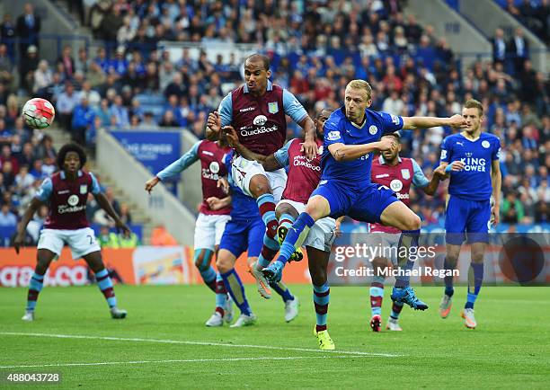 Ritchie De Laet of Leicester City beats Gabriel Agbonlahor and Leandro Bacuna of Aston Villa to score their first goal during the Barclays Premier...