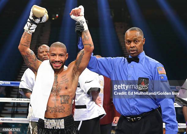 Referee Kenny Bayliss raises the arm of Ashley Theophane after his knockout win over Angino Perez during their welterweight fight at the MGM Grand...