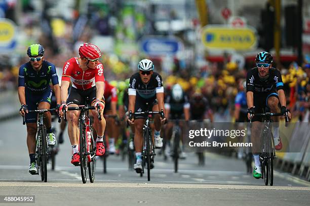 Andre Greipel of Germany and Lotto-Soudal looks over at Elia Viviani of Italy and Team SKY after claiming victory on the finish line of stage eight...