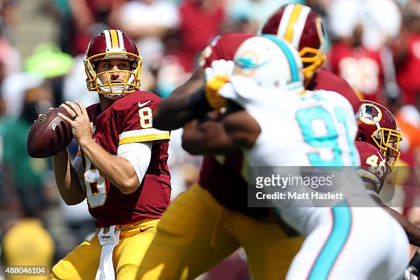 Quarterback Kirk Cousins of the Washington Redskins drops back in the first half during a game against the Miami Dolphins at FedExField on September...