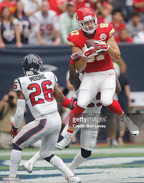 Travis Kelce of the Kansas City Chiefs catches a touchdown pass against Rahim Moore of the Houston Texans in the first quarter in a NFL game on...