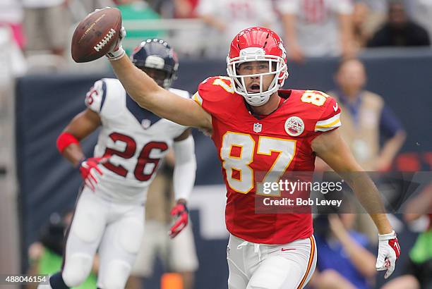 Travis Kelce of the Kansas City Chiefs celebrates after catching a touchdown pass against Rahim Moore of the Houston Texans in the first quarter in a...