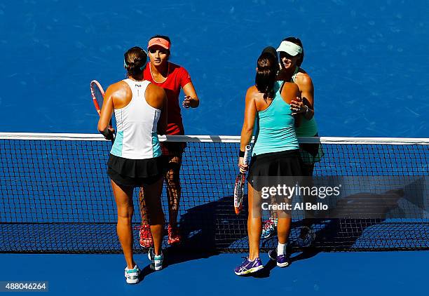 Martina Hingis of Switzerland and Sania Mirza of India shakes hands with Casey Dellacqua of Australia and Yaroslava Shvedova of Kazakhstan after...