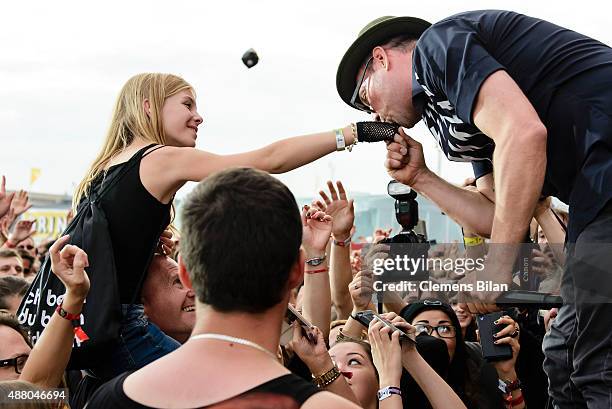 Arnim Teutoburg-Weiss, singer of the band Beatsteaks, gives a female fan a kiss on the hand during the second day of the Lollapalooza Berlin music...