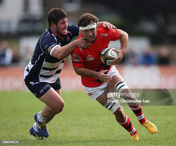 Ryan Hodson of Welsh is tackled by Marc Jones of Bristol during the Greene King IPA Championship match between London Welsh and Bristol at Old Deer...