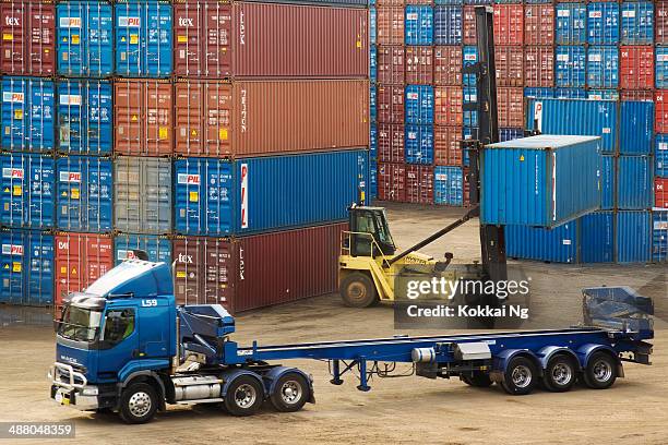 forklift lifting container off truck at port botany - port botany stock pictures, royalty-free photos & images