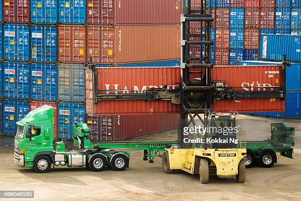forklift lifting container off truck at port botany - port botany stock pictures, royalty-free photos & images