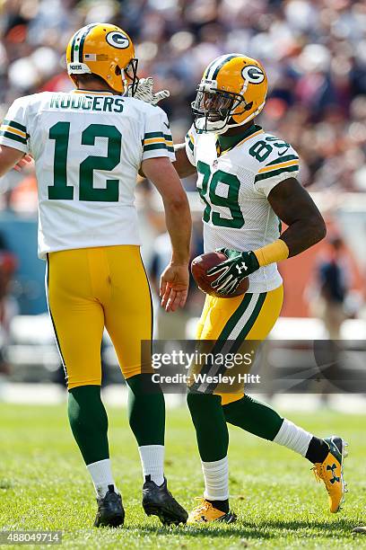 James Jones of the Green Bay Packers celebrates with quarterback Aaron Rodgers after scoring a touchdown in the first quarter against the Chicago...