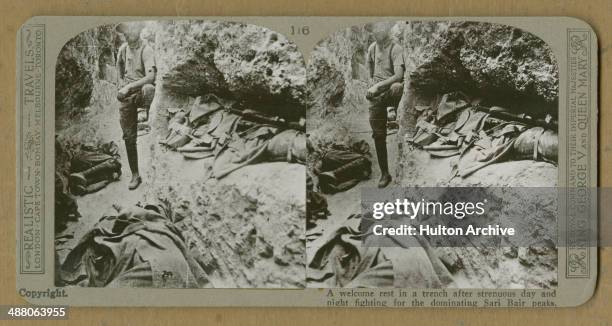 Stereoscopic image of a British Empire soldier posing by his sleeping comrades in a trench during the Battle of Sari Bair in the Gallipoli Campaign,...