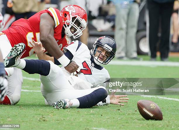 Justin Houston of the Kansas City Chiefs forces a fumble on Brian Hoyer of the Houston Texans during the first half at NRG Stadium on September 13,...