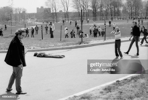 Young woman holds her hands to her head as she stands near the body of student Jeffrey Miller, who was shot and killed by guardsmen during an...