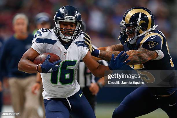 Tyler Lockett of the Seattle Seahawks is pushed out of bounds in the first half by James Laurinaitis of the St. Louis Rams at the Edward Jones Dome...