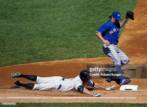 Dickey of the Toronto Blue Jays beats Brett Gardner of the New York Yankees to first base for the out in the third inning at Yankee Stadium on...