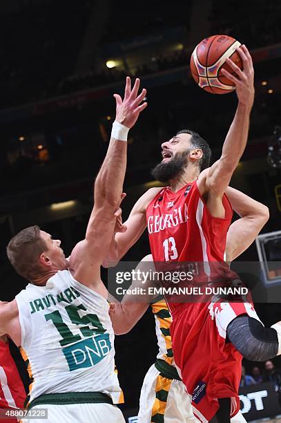 Lithuania's center Robertas Javtokas defends against Georgia's small forward Viktor Sanikidze during the round of 16 basketball match between...