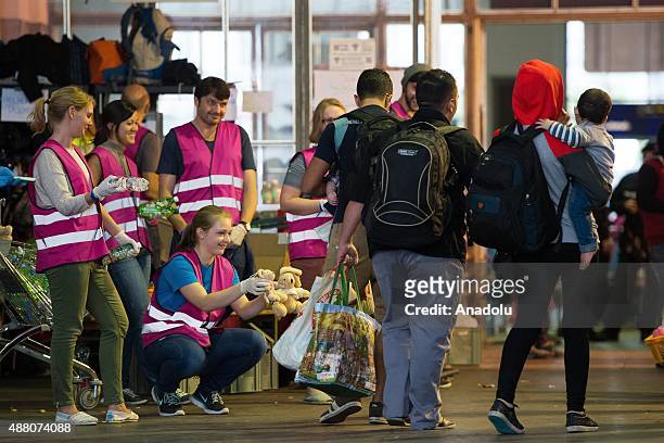 Volunteers welcome refugees at the main railway station on September 13, 2015 in Munich, Germany. Hundreds of refugees, mainly from Syria and Iraq,...