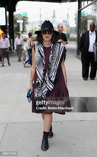 Farah Alimi @farahjaka is seen wearing Skingraft scarf, Alexander Wang H&M dress, vintage hat, Desigual Clutch outside NYFW: The Shows HQ during...