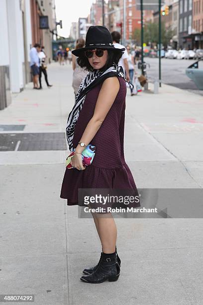 Farah Alimi @farahjaka is seen wearing Skingraft scarf, Alexander Wang H&M dress, vintage hat, Desigual Clutch outside NYFW: The Shows HQ during...