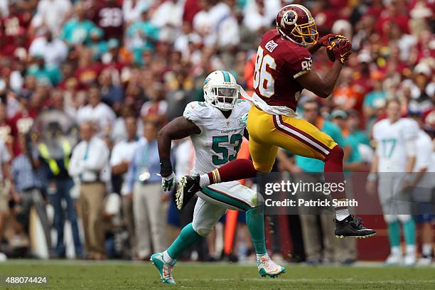 Tight end Jordan Reed of the Washington Redskins catches the ball while outside linebacker Jelani Jenkins of the Miami Dolphins defends in the second...