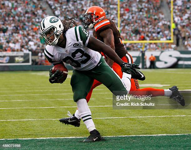 Chris Ivory of the New York Jets scores a touchdown as Donte Whitner of the Cleveland Browns chases during the third quarter of a game at MetLife...