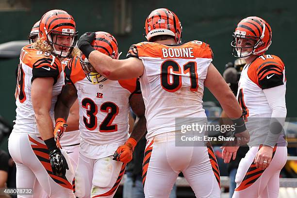 Ryan Hewitt, Jeremy Hill, Russell Bodine and Andy Dalton celebrate a touchdown by Hill during the first half of their NFL game against the Oakland...