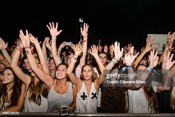 Fans cheer as DJ Martin Garrix performs live on stage during the second day of the Lollapalooza Berlin music festival at Tempelhof Airport on...