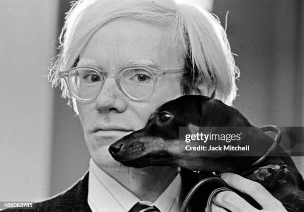 Andy Warhol poses with his beloved dachshund Archie in November 1973.