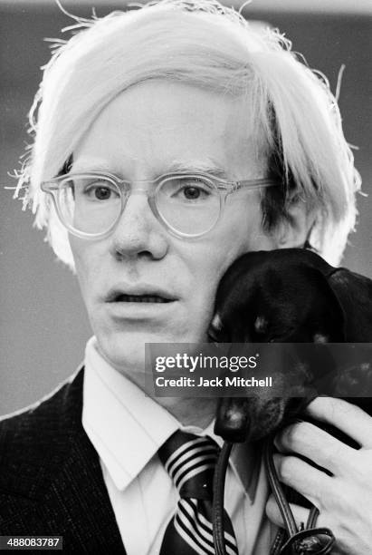 Andy Warhol poses with his beloved dachshund Archie in November 1973.