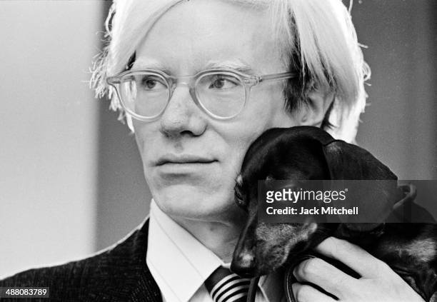 Andy Warhol poses with his beloved dachshund Archie in November 1973.