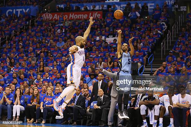 Courtney Lee of the Memphis Grizzlies takes a shot against Derek Fisher of the Oklahoma City Thunder in Game Seven of the Western Conference...