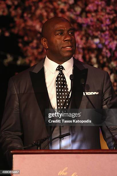 Earvin "Magic" Johnson accepts an award onstage at the 2014 Steve & Marjorie Harvey Foundation Gala presented by Coca-Cola at the Hilton Chicago on...