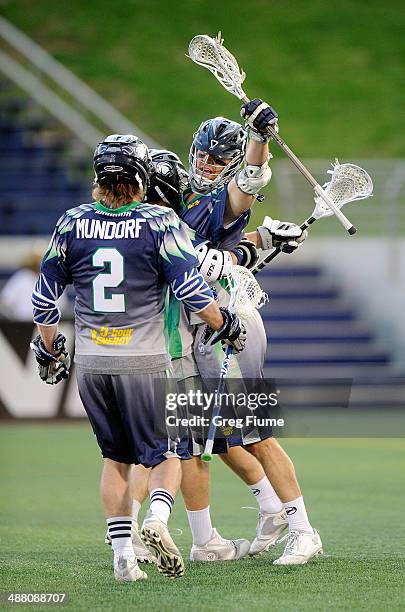 Stephen Peyser of the Chesapeake Bayhawks celebrates with teammates after scoring in the first quarter against the New York Lizards at Navy-Marine...