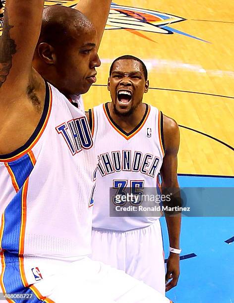 Kevin Durant of the Oklahoma City Thunder celebrates a dunk by Caron Butler against the Memphis Grizzlies in Game Seven of the Western Conference...