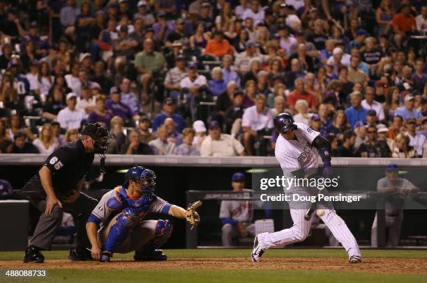 Troy Tulowitzki of the Colorado Rockies hits a single off of relief pitcher Daisuke Matsuzaka of the New York Mets for his 1000th career hit as...