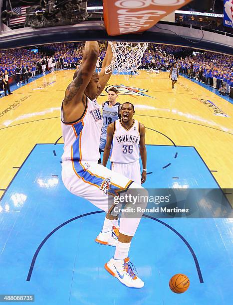 Kevin Durant of the Oklahoma City Thunder celebrates a dunk by Caron Butler against the Memphis Grizzlies in Game Seven of the Western Conference...