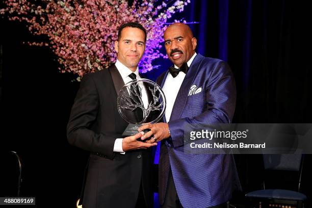 Steve Pemberton of Walgreen accepts an award from Steve Harvey on stage at the 2014 Steve & Marjorie Harvey Foundation Gala presented by Coca-Cola at...