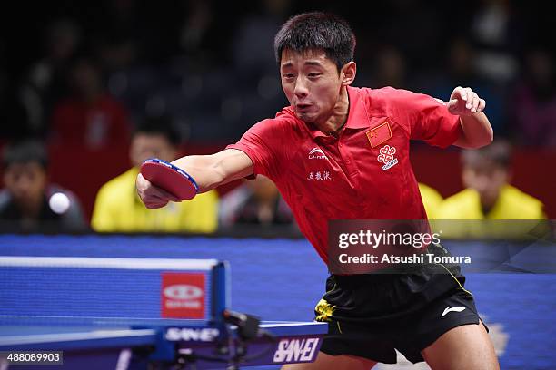 Jike Zhang of China plays a backhand against Sheng-Sheng Huang of Chinese Taipei during day seven of the 2014 World Team Table Tennis Championships...