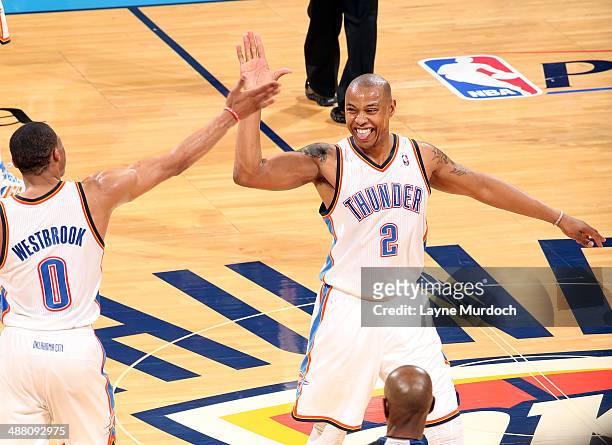 Russell Westbrook and Caron Butler of the Oklahoma City Thunder celebrate after a win against the Memphis Grizzlies in Game Seven of the Western...