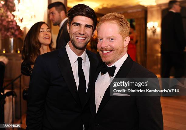 Justin Mikita and Jesse Tyler Ferguson attend the Bloomberg & Vanity Fair cocktail reception following the 2014 WHCA Dinner at Villa Firenze on May...