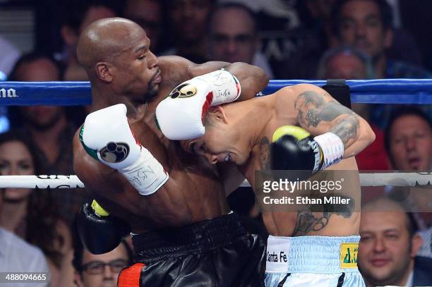 Floyd Mayweather Jr. And Marcos Maidana exchange blows during their WBC/WBA welterweight unification fight at the MGM Grand Garden Arena on May 3,...