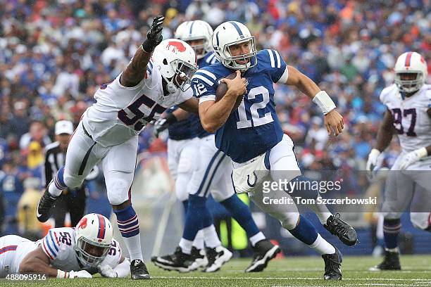 Andrew Luck of the Indianapolis Colts is chased down by Jerry Hughes of the Buffalo Bills during the second half at Ralph Wilson Stadium on September...