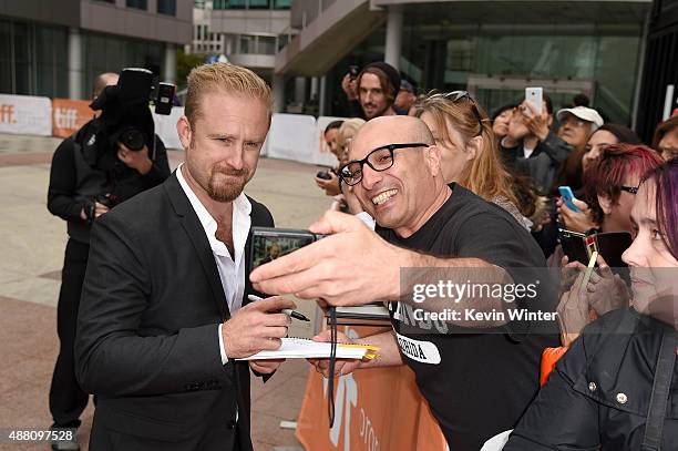 Actor Ben Foster takes a selfie with fans at "The Program" premiere during the 2015 Toronto International Film Festival at Roy Thomson Hall on...