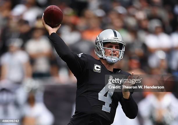 Derek Carr of the Oakland Raiders throws a pass against the Cincinnati Bengals during the first half of their NFL game at O.co Coliseum on September...
