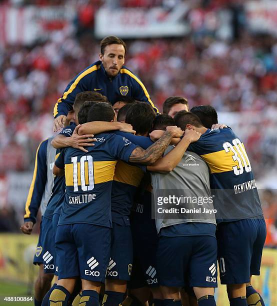 Nicolas Lodeiro, of Boca Juniors, celebrates with teammates, after scoring the opening goal during a match between River Plate and Boca Juniors as...