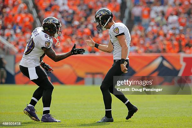 Kicker Justin Tucker of the Baltimore Ravens celebrates with wide receiver Steve Smith after scoring on a 52 yard field goal in the second quarter of...