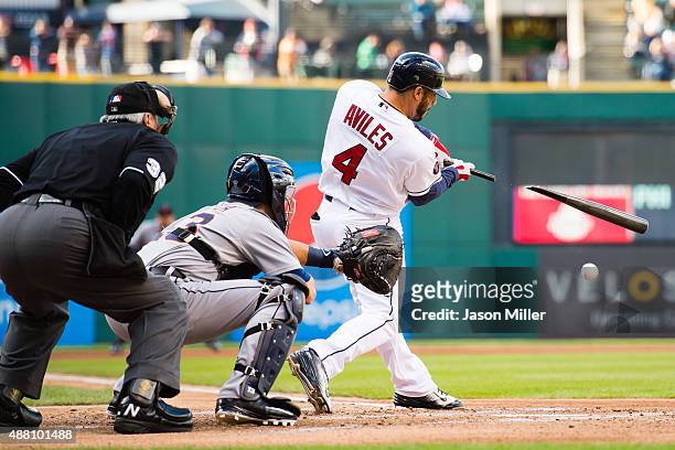 Home plate umpire Dana DeMuth and catcher Alex Avila of the Detroit Tigers watch as Mike Aviles of the Cleveland Indians hits a single during the...