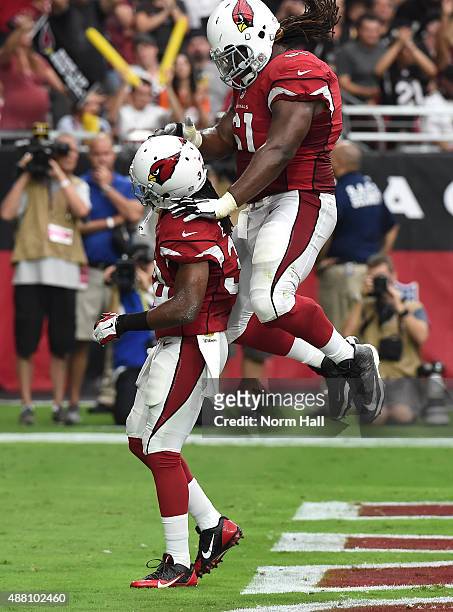 Guard Jonathan Cooper of the Arizona Cardinals celebrates a one-yard touchdown run by running back Andre Ellington during the second quarter of the...