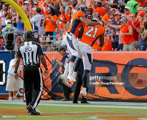 Cornerback Aqib Talib of the Denver Broncos celebrates with cornerback Chris Harris after returning an interception for a touchdown in the third...