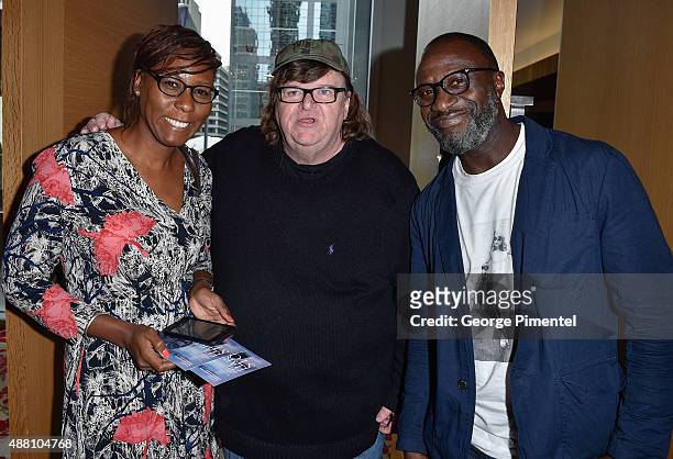 Dionne Walker, director Michael Moore and George Amponsah attend the Ebert Tribute Lunch in honour of Ava DuVernay during the 2015 Toronto...