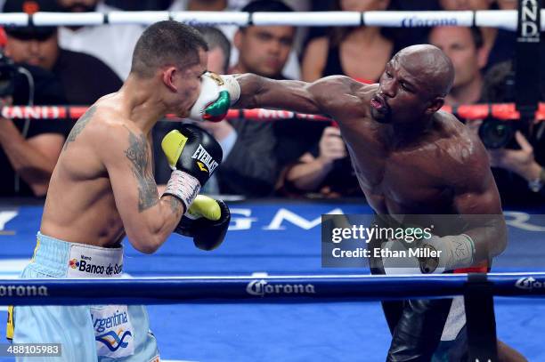 Floyd Mayweather Jr. Throws a right at Marcos Maidana during their WBC/WBA welterweight unification fight at the MGM Grand Garden Arena on May 3,...