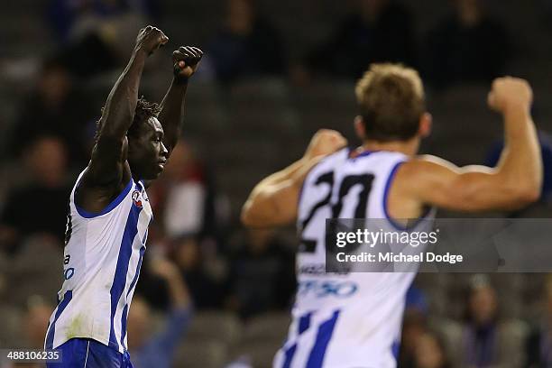 Majak Daw and Drew Petrie of the Kangaroos celebrate a goal during the round seven AFL match between the North Melbourne Kangaroos and the Gold Coast...